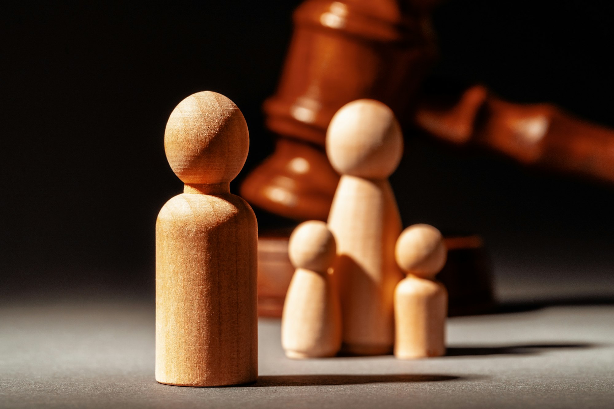 Wooden toy family and judge mallet. Family divorce concept